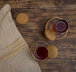 biscuits with two glasses of tea on wooden table as chat place