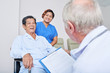 © DragonImages - Anonymous elderly doctor and cheerful nurse looking at laughing senior man on wheelchair in hospital