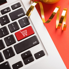 Fototapete - Laptop keyboard with icon shopping cart closeup