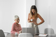© LUMINA IMAGES - Two beautiful smiling businesswomen working together at meeting room.
