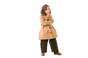 Wall Mural - thoughtful little child in trench coat isolated on white