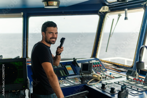 Fotografía Marine navigational officer is reporting by VHF radio during navigation watch