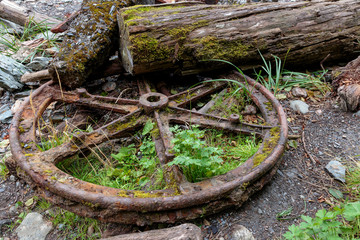 Old rusty wheels on the beach near the Treadwell mine historic park in Juneau Alaska