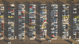 Top down view from drone on mall parking with many cars.