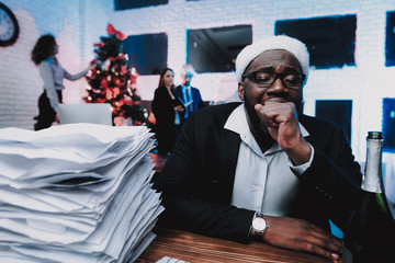 Wall Mural - Tired Man in Cap Working in Office on New Year Eve