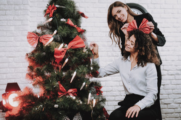 Wall Mural - Happy Workers Decorating Christmas Tree in Office.