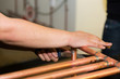 A plumber uses a file to smooth down the joint on a set of copper pipes after they've been welded together.