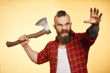 Wall Mural - Dangerous brutal Aggressive bearded man with axe. man run into camera