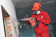 © Kadmy - worker with demolition hammer breaking interior wall