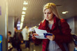 © Angelov - Pretty young woman at the airport with tickets and passports