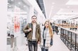 © velimir - young couple in love are walking through the shopping center for shopping  in winter clothes.  Christmas holidays