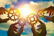 © gerasimov174 - Business concept idea. four hands of businessmen collect a puzzle from gears. Cooperation, teamwork, strategy, creativity, innovation.