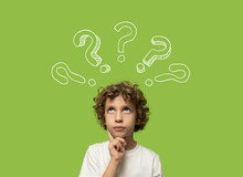 Thinking Kid - 6 Years Old Child Thinking And Asking Himself A Question. Isolated On Green Background And Question Mark Over His Head