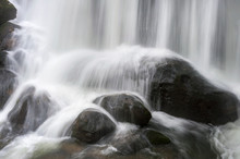 Closeup Of A Waterfall Cascading Over Rocks. Flowing Water From A Waterfall In Whatcom Falls Park, Bellingham, Washington.