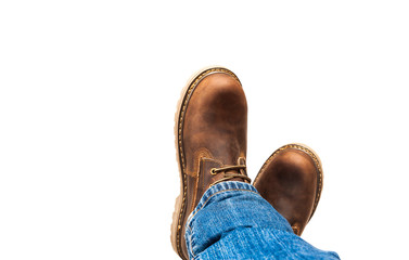 Men's brown boots and blue jeans isolated