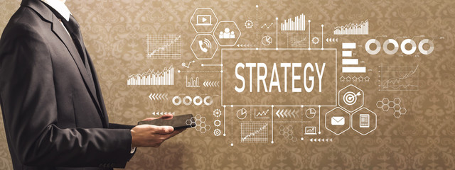Poster - Strategy with businessman holding a tablet computer on a dark vintage background