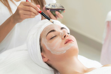 Beautiful woman having a facial treatment at spa.