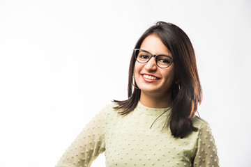 Pretty Indian young girl wearing clear eye Glasses or Spectacles with a smile, standing isolated over white background