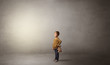 © ra2 studio - Little waggish kid staying alone in a big empty room with his plush