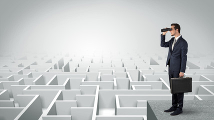 Wall Mural - businessman standing on maze and looking forward to the future concept