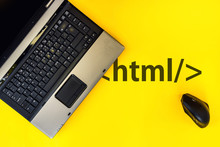 HTML Hyper Text Markup Language. Laptop And Vertical Mouse On Yellow Background With Html Tag