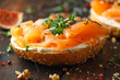 Salmon Bagel Sandwich with figs, cress salad, walnuts, cream cheese and grain on rustic wooden background. healthy breakfast
