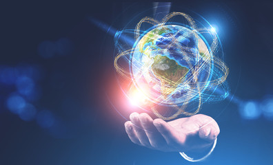 Poster - Man hand holding earth as atom