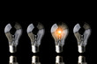 © whyframeshot - creativity startup business ideas concept with glow light bulb on black background