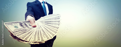 Cuadros en Lienzo Business man displaying a spread of cash