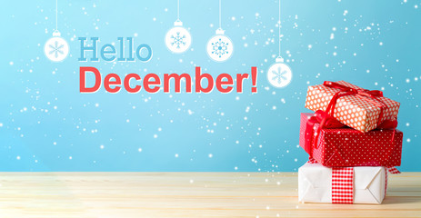 Poster - Hello December message with Christmas gift boxes with red ribbons