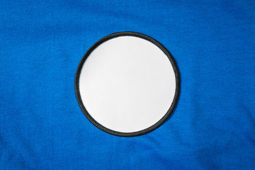 blank arm patch on blue sport shirt. white team logo and emblem for your montage or edit.