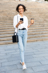 Canvas Print - Beautiful young woman walking downstairs at the street