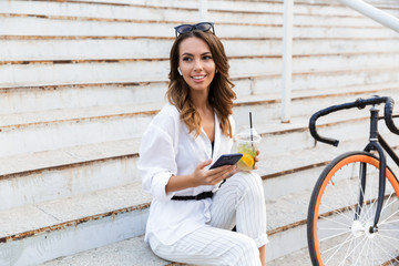 Wall Mural - Attractive young woman spending time at the park