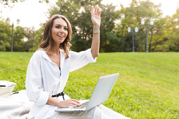 Canvas Print - Cheerful young woman spending time at the park