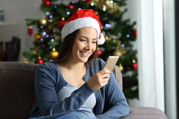 Wall Mural - Woman checking phone messages in christmas