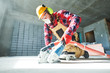 © Kadmy - builder at work. cutting concrete floor for cabling by diamond slitting machine