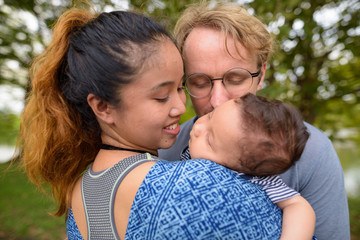 Multi-ethnic young family bonding together at the park