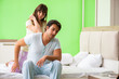 © Elnur - Woman doing massage to her husband in bedroom