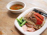 Fototapeta  - roasted duck over stream rice with soup on bagasse dish