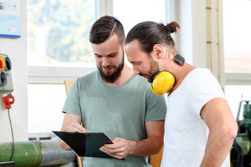 two worker in a carpenter's workshop