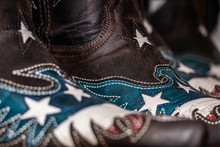 Traditional American Handmade Leather Cowboy Boots, Western Show, Rodeo Market And Riding Gear On Display. National Folklore, Outdoor And Adventure  Lifestyle Concept.