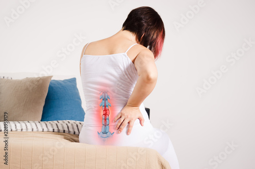 Fotomural Pain in the spine, woman with backache at home, injury in the lower back