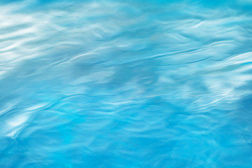 The smooth natural blue water background with bokeh  abstract on the sea or ocean,vintage and soft colored blur.