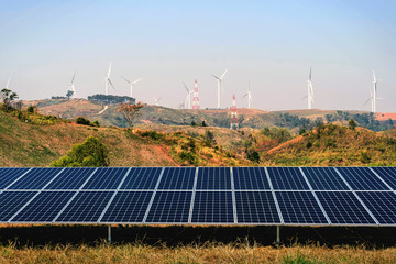 Wall Mural - solar panel with turbine on hill and blue sky background. concept clean power energy