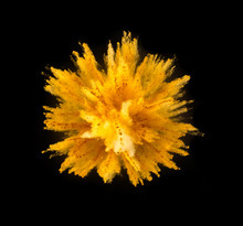 Explosion Of Yellow Powder On Black Background