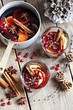 Mulled wine,punch,bowle oder spiced tea : winter traditional warming drinks with spicy,citrus fruits and pomegranate . Rustic style.