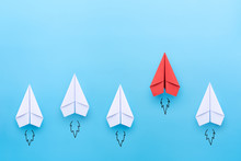 Red Paper Plane Leading Among A White Planes On Blue Background. Business Competition And Leadership Concept