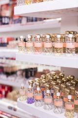 Wall Mural - Bottles of perfume for sale on shelves