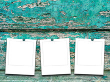 Three Blank Square Instant Photo Frames On Scratched Turquoise Wooden Boards Background