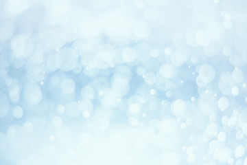 Abstract white bokeh on blue background.